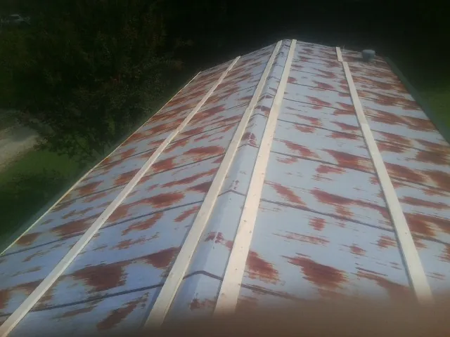 Rusted metal roof panels with new wood purlins before replacement — Storm Damage Roof Repair in Cuba by Roofing Brothers